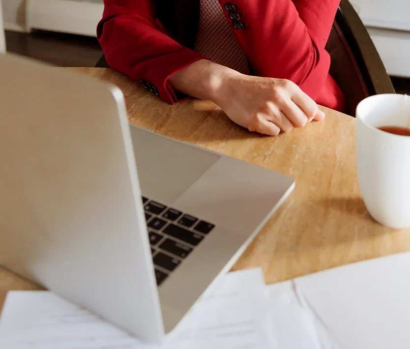 Lina Stillman working with her laptop and papers on a table